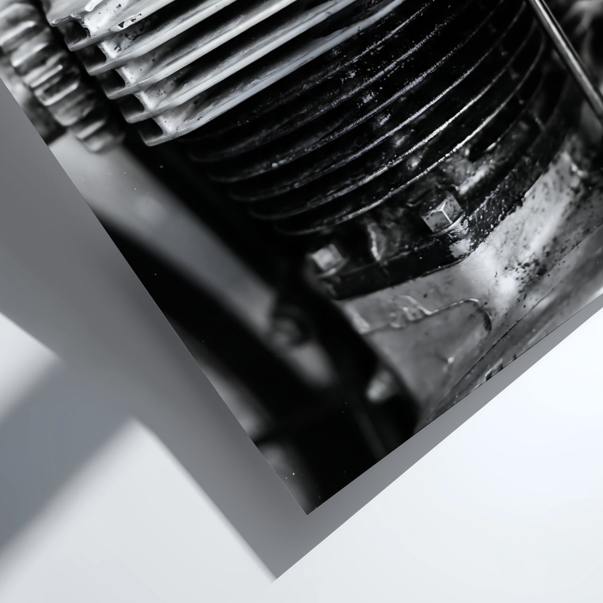 Wall decor featuring black and white close-up photo of motorcycle engine cylinder with metal textures