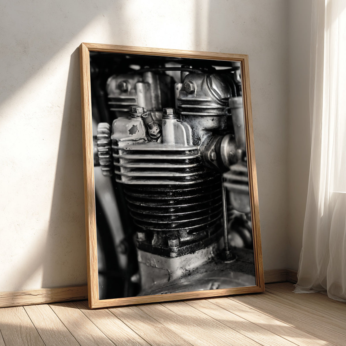 Wall decor featuring black and white close-up photo of motorcycle engine cylinder with metal textures