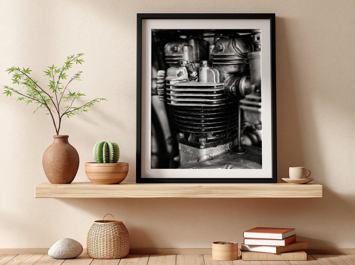 Wall decor featuring black and white close-up photo of motorcycle engine cylinder with metal textures