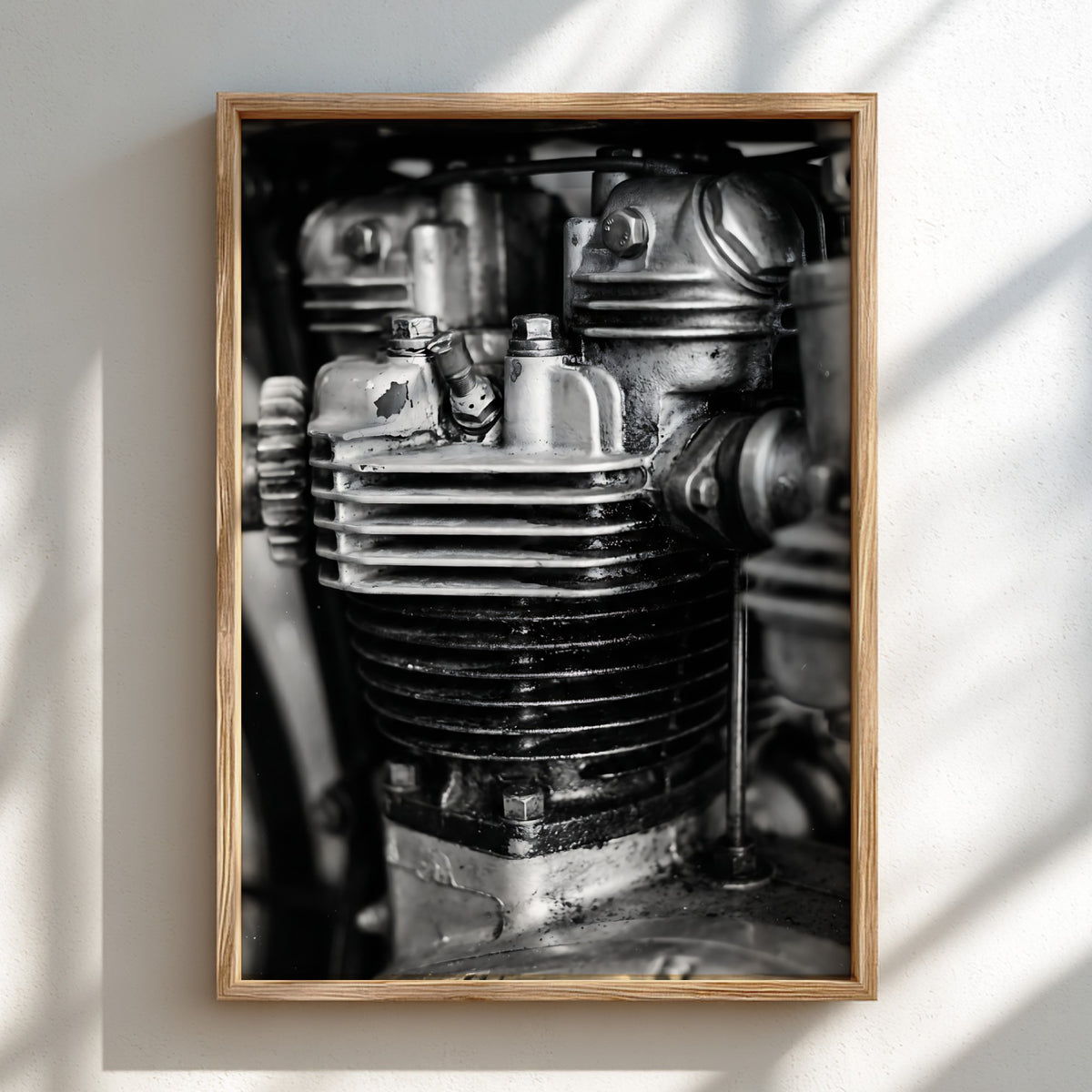 Wall decor featuring black and white close-up photo of motorcycle engine cylinder with metal textures