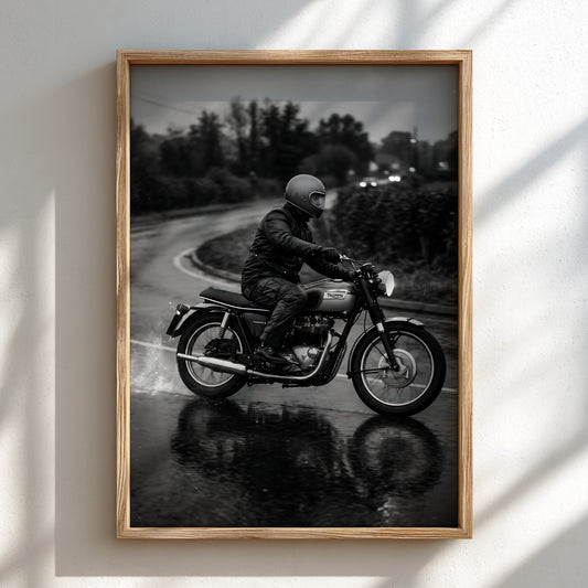 Black and white wall decor showing motorcyclist riding on wet road with reflective surface and moody