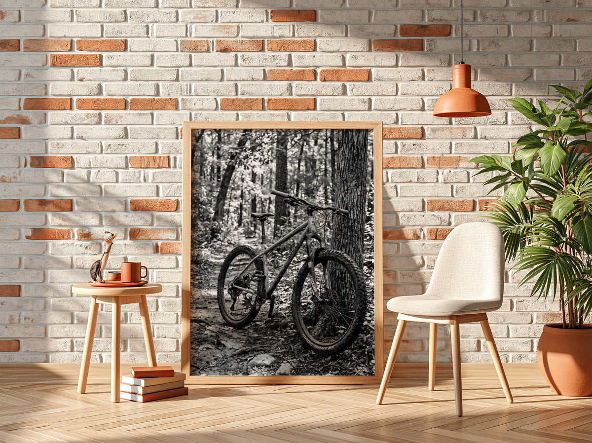 Black and white wall decor showing mountain bike resting against tree in forest with textured bark