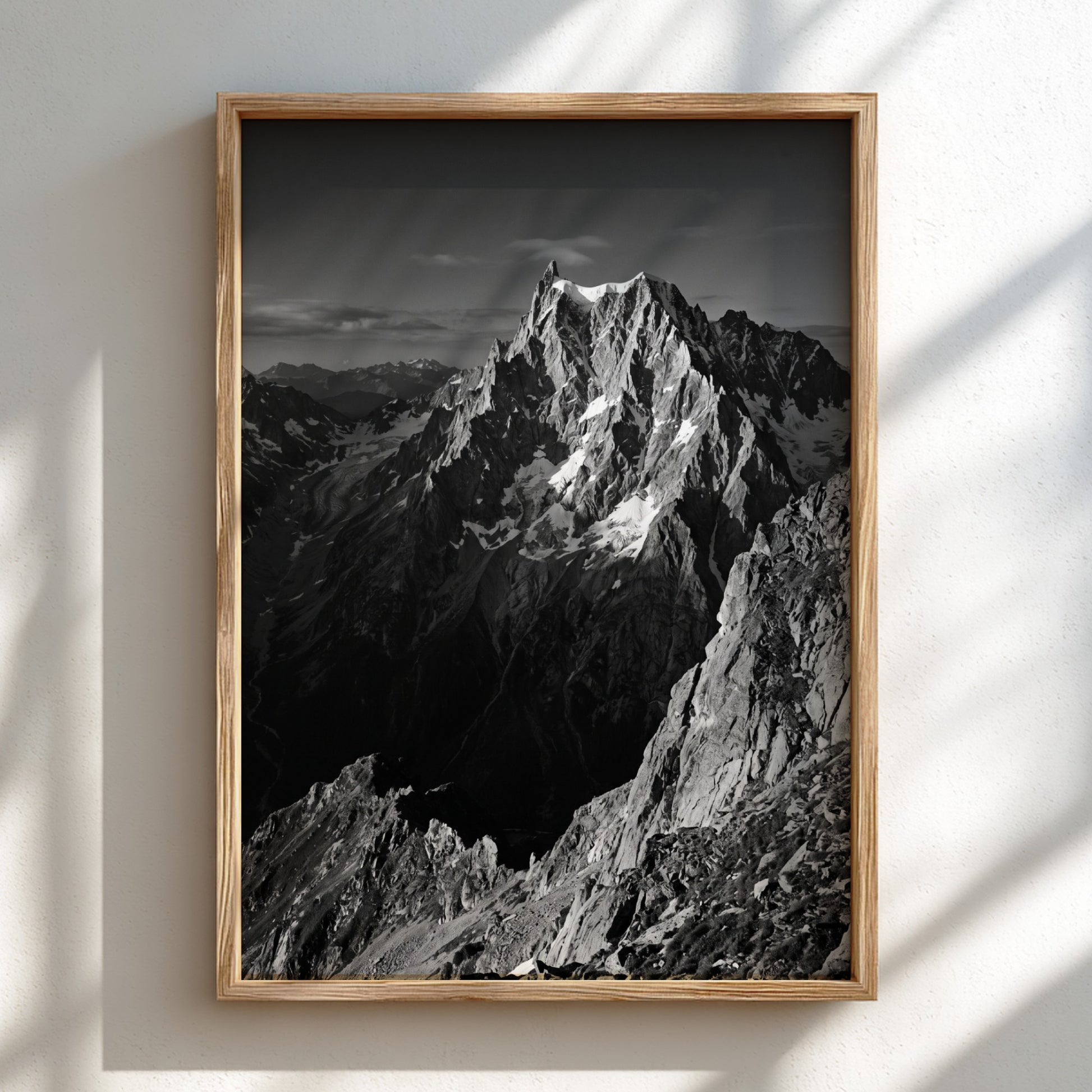 Black and white poster of mountain peak catching light with rugged rocky texture
