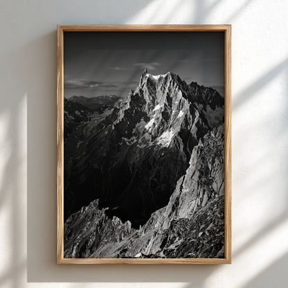 Black and white poster of mountain peak catching light with rugged rocky texture