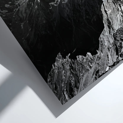 Black and white poster of mountain peak catching light with rugged rocky texture