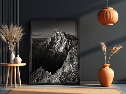 Black and white poster of mountain peak catching light with rugged rocky texture