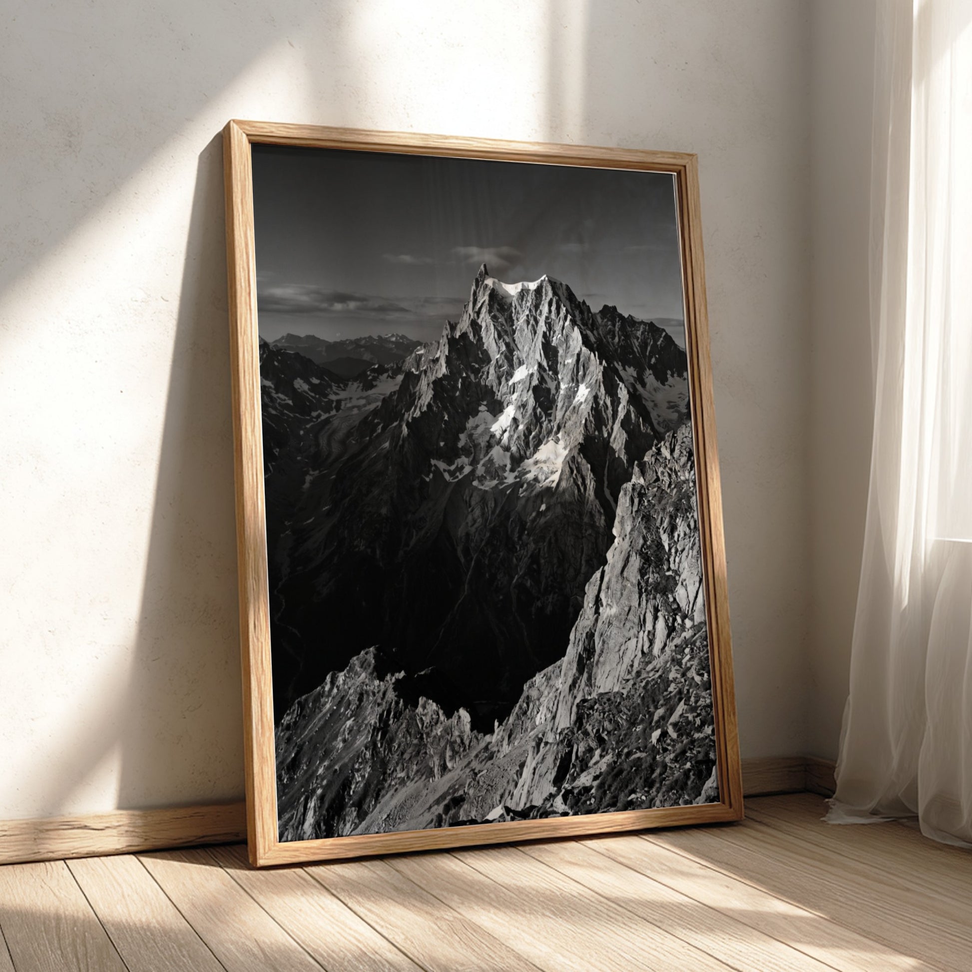 Black and white poster of mountain peak catching light with rugged rocky texture