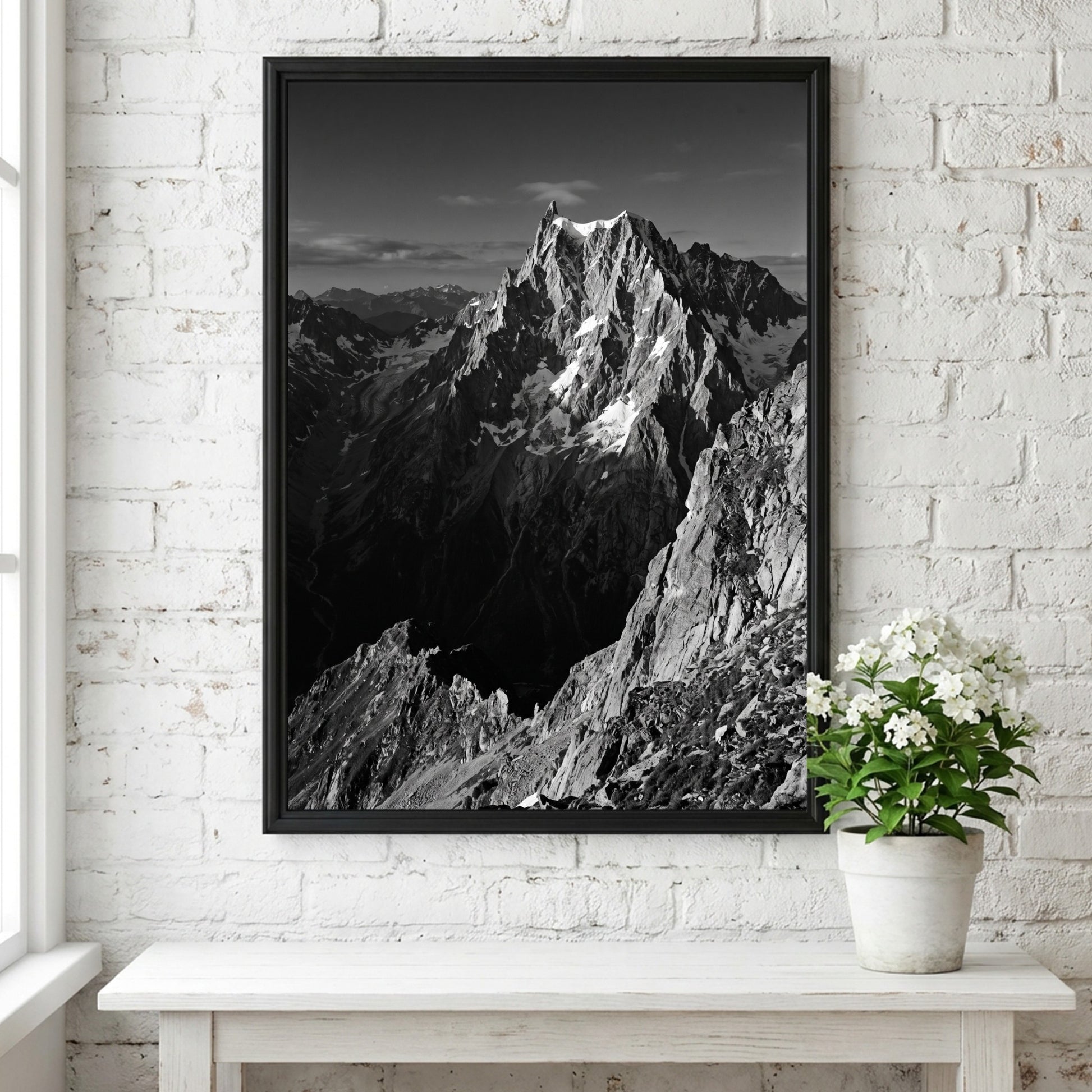 Black and white poster of mountain peak catching light with rugged rocky texture