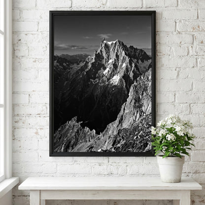 Black and white poster of mountain peak catching light with rugged rocky texture