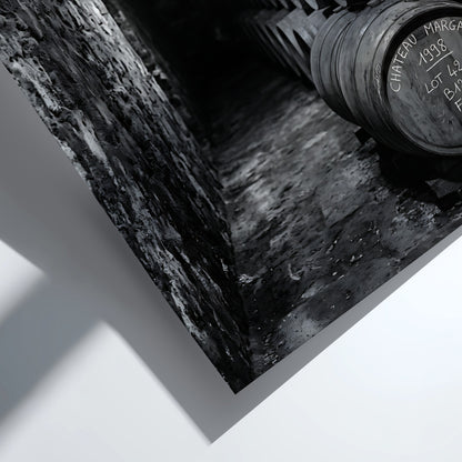 Wall decor featuring black and white photograph of oak wine barrels stacked in stone cellar under soft light