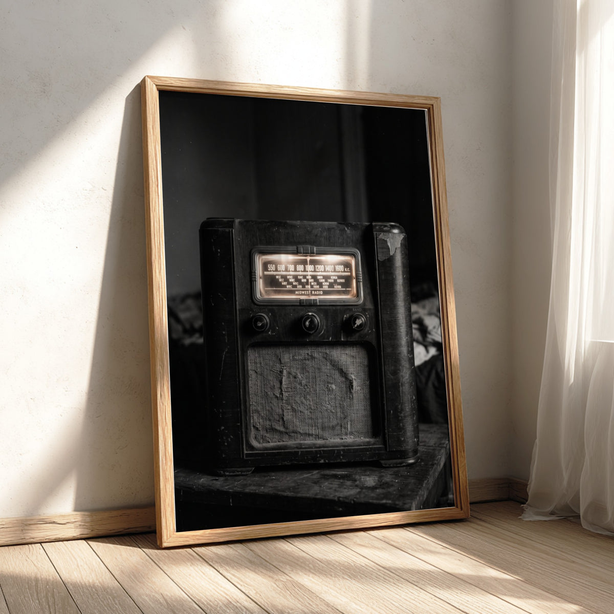 Vintage wall decor featuring old wooden cabinet radio in black and white with glowing dials