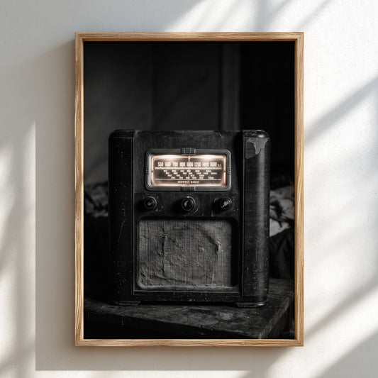 Vintage wall decor featuring old wooden cabinet radio in black and white with glowing dials