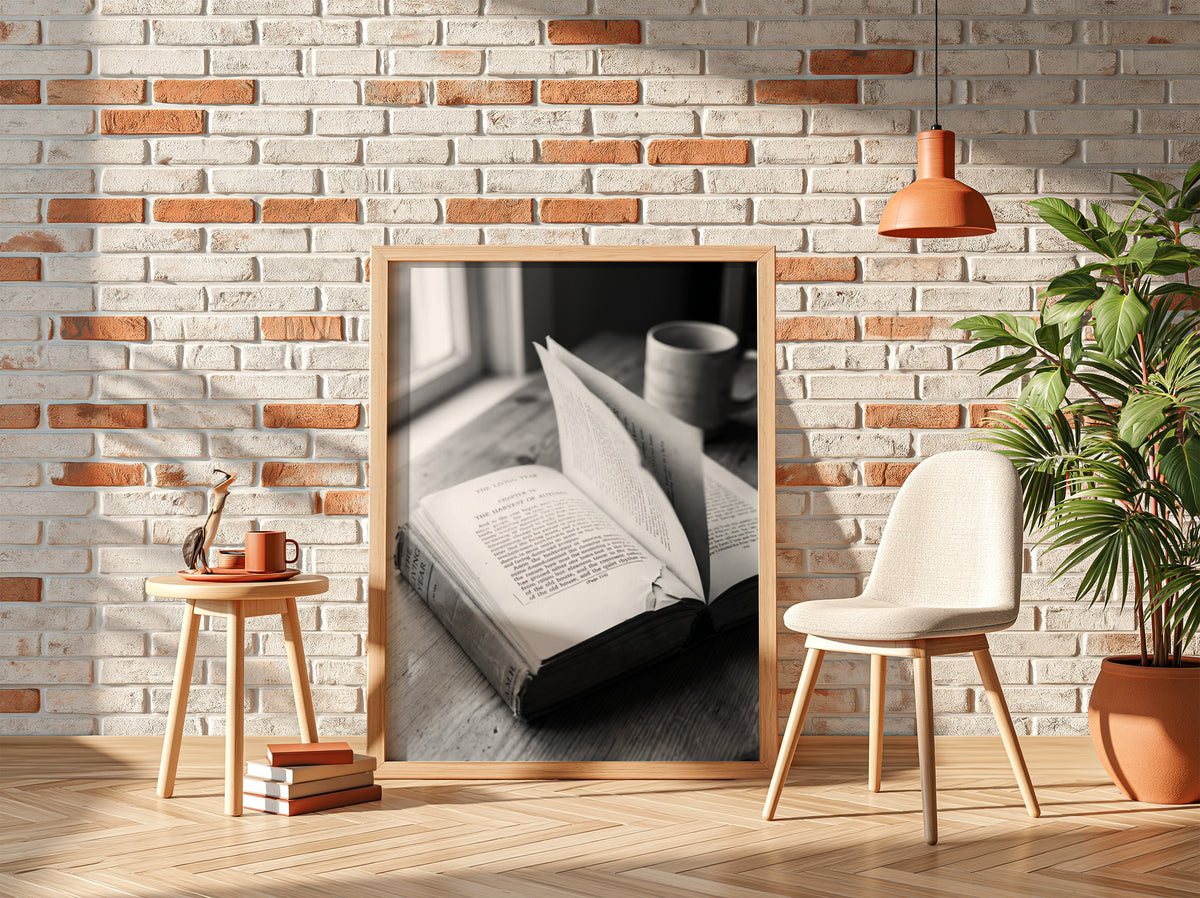 Black and white wall decor showing an open book with pages turning on a wooden surface with soft natural light