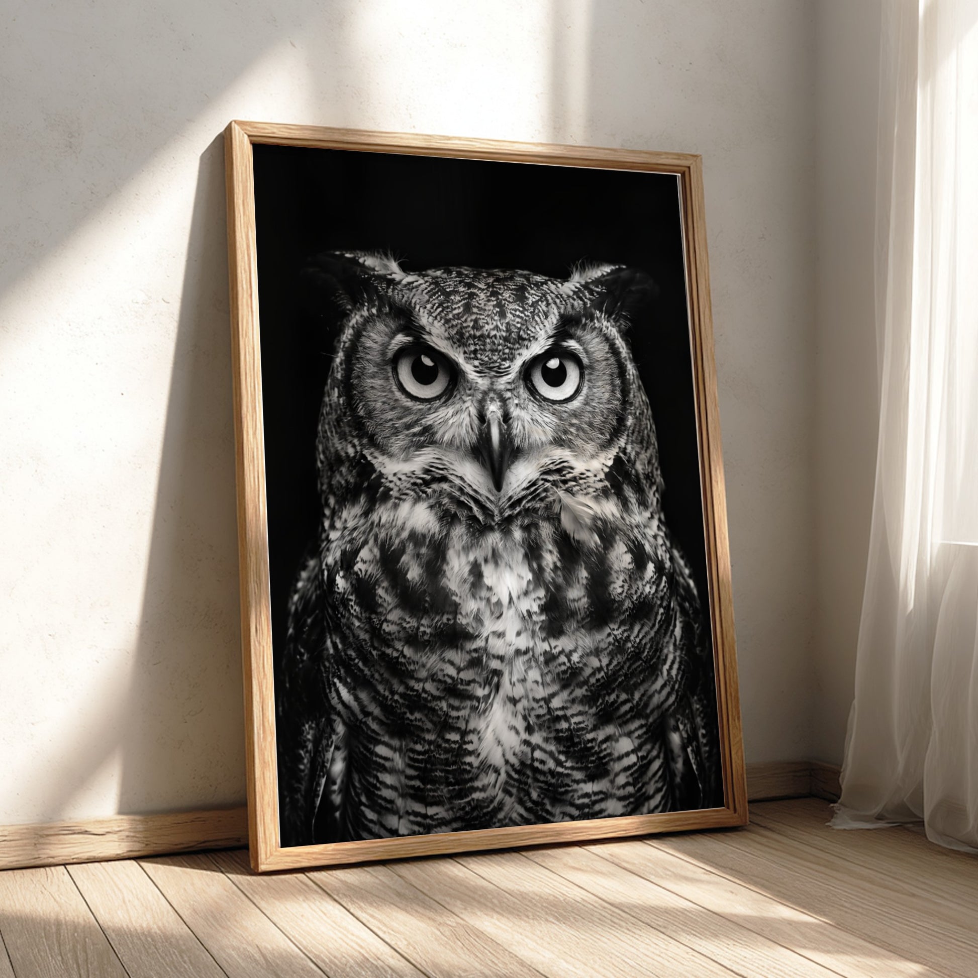black and white owl portrait poster with detailed feathers and piercing eyes on dark background