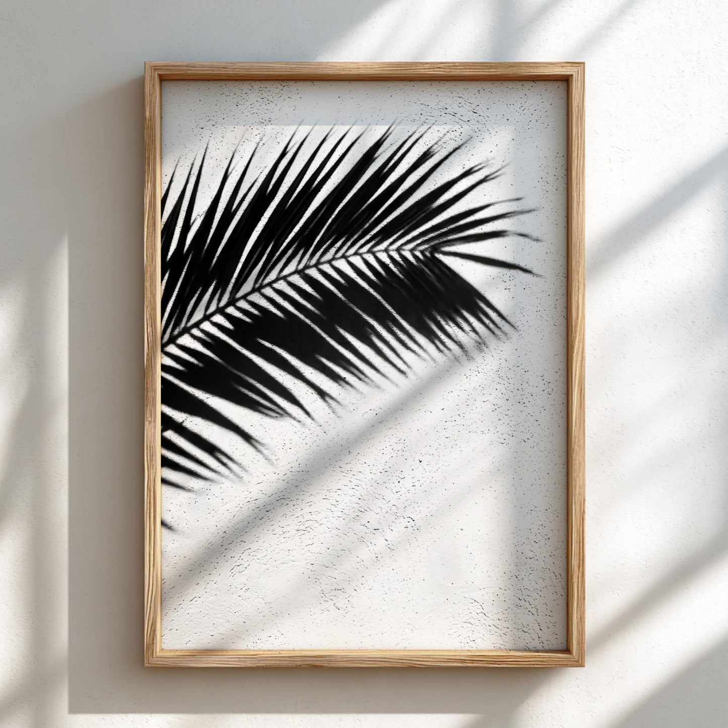 Wall decor poster with black palm frond shadows on white stucco textured background in minimalist style