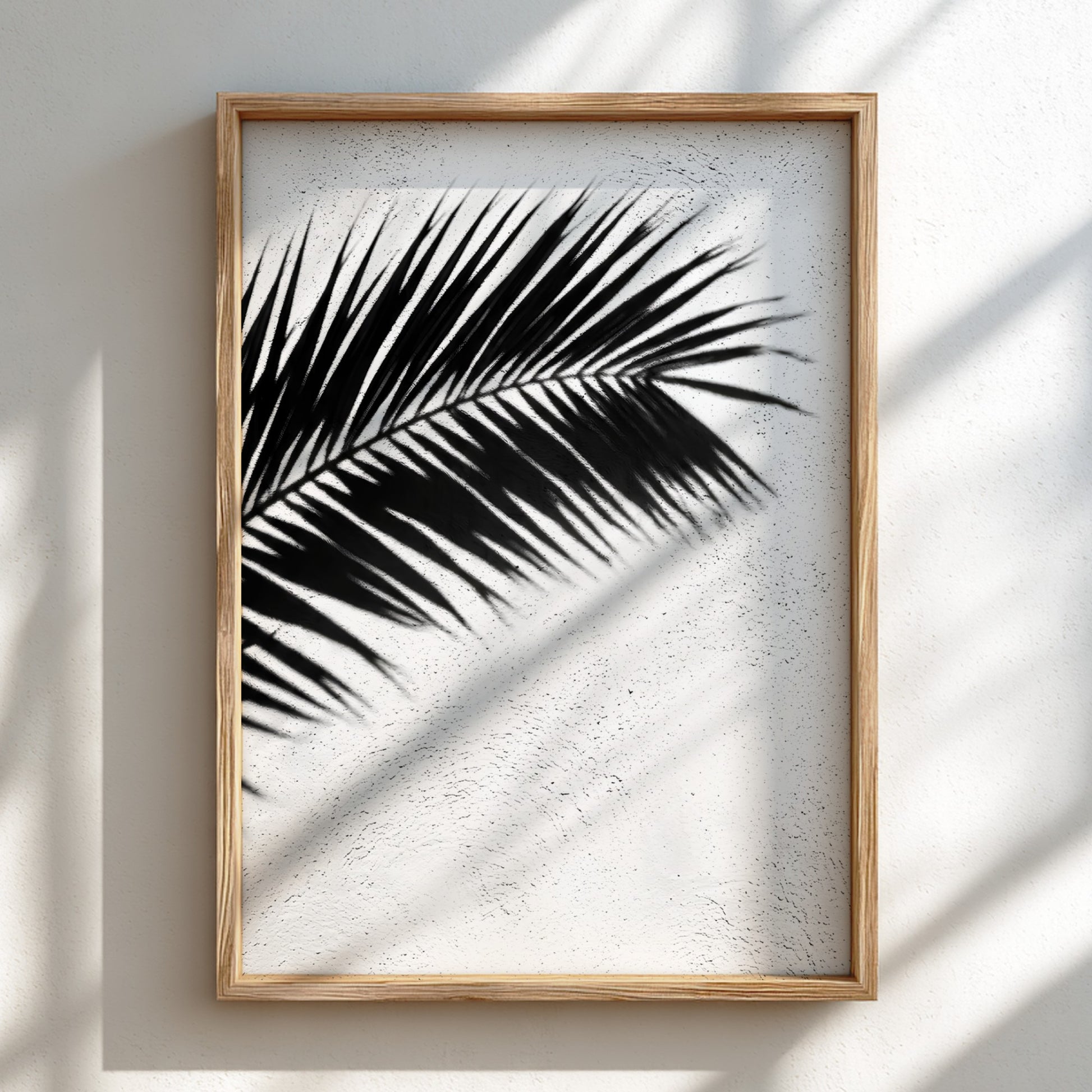 Wall decor poster with black palm frond shadows on white stucco textured background in minimalist style