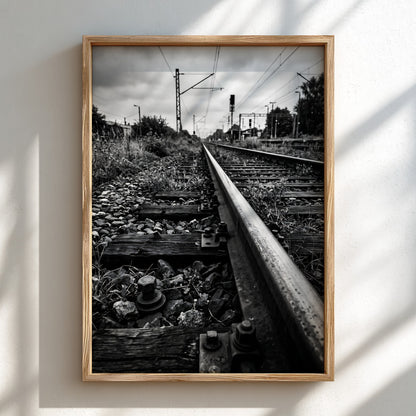Black and white poster of railway tracks converging with wooden sleepers and overhead power lines