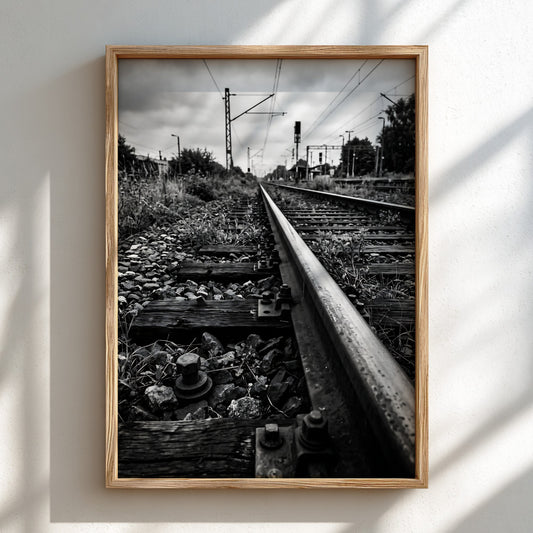 Black and white poster of railway tracks converging with wooden sleepers and overhead power lines