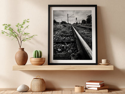 Black and white poster of railway tracks converging with wooden sleepers and overhead power lines