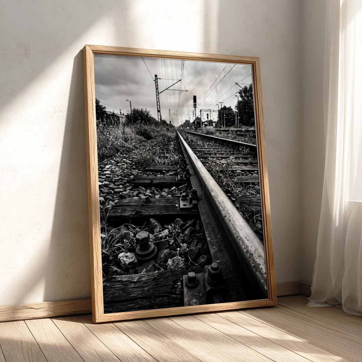 Black and white poster of railway tracks converging with wooden sleepers and overhead power lines