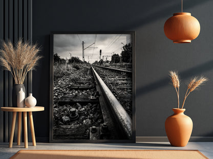 Black and white poster of railway tracks converging with wooden sleepers and overhead power lines