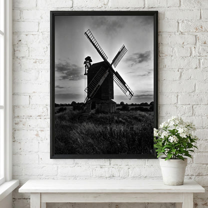 Black and white poster of rural windmill silhouette at dusk with moody sky and tall grass