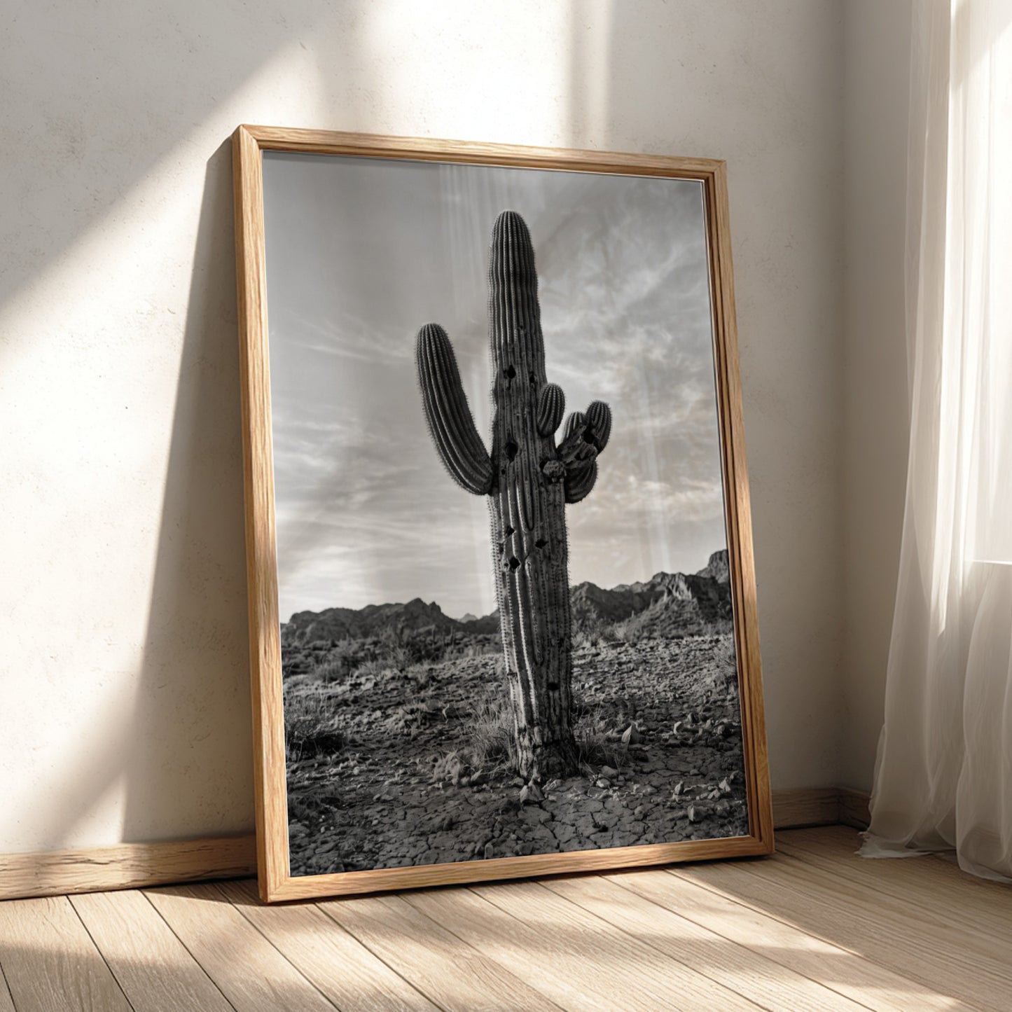 Poster of a monochrome saguaro cactus in desert with rocky ground and cloudy sky