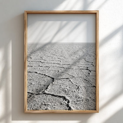 black and white wall decor of salt flat with cracked ground stretching to horizon in minimalist style