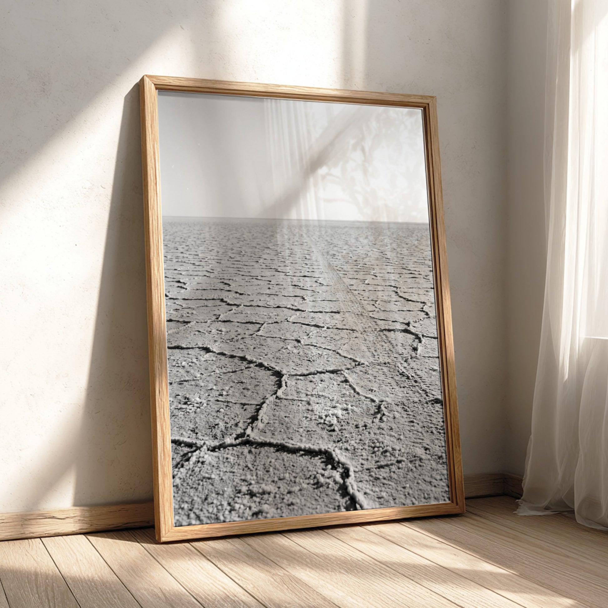 black and white wall decor of salt flat with cracked ground stretching to horizon in minimalist style