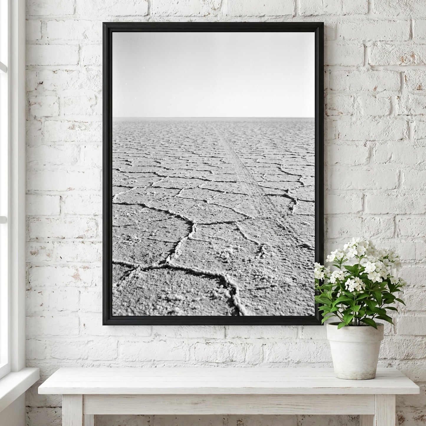 black and white wall decor of salt flat with cracked ground stretching to horizon in minimalist style