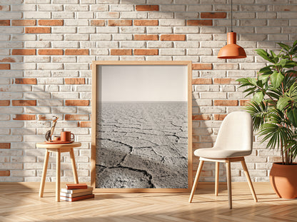black and white wall decor of salt flat with cracked ground stretching to horizon in minimalist style
