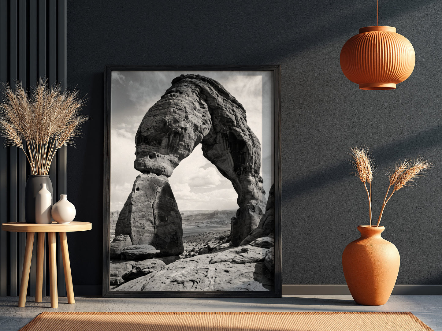 Black and white wall decor of sandstone arch in desert with textured rock and cloudy sky