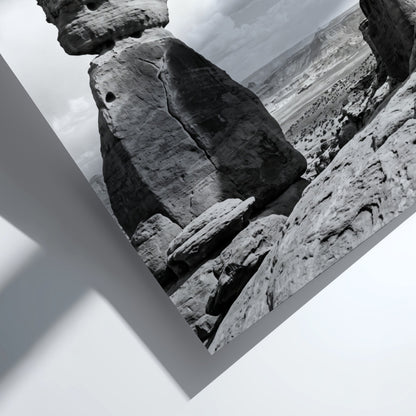 Black and white wall decor of sandstone arch in desert with textured rock and cloudy sky