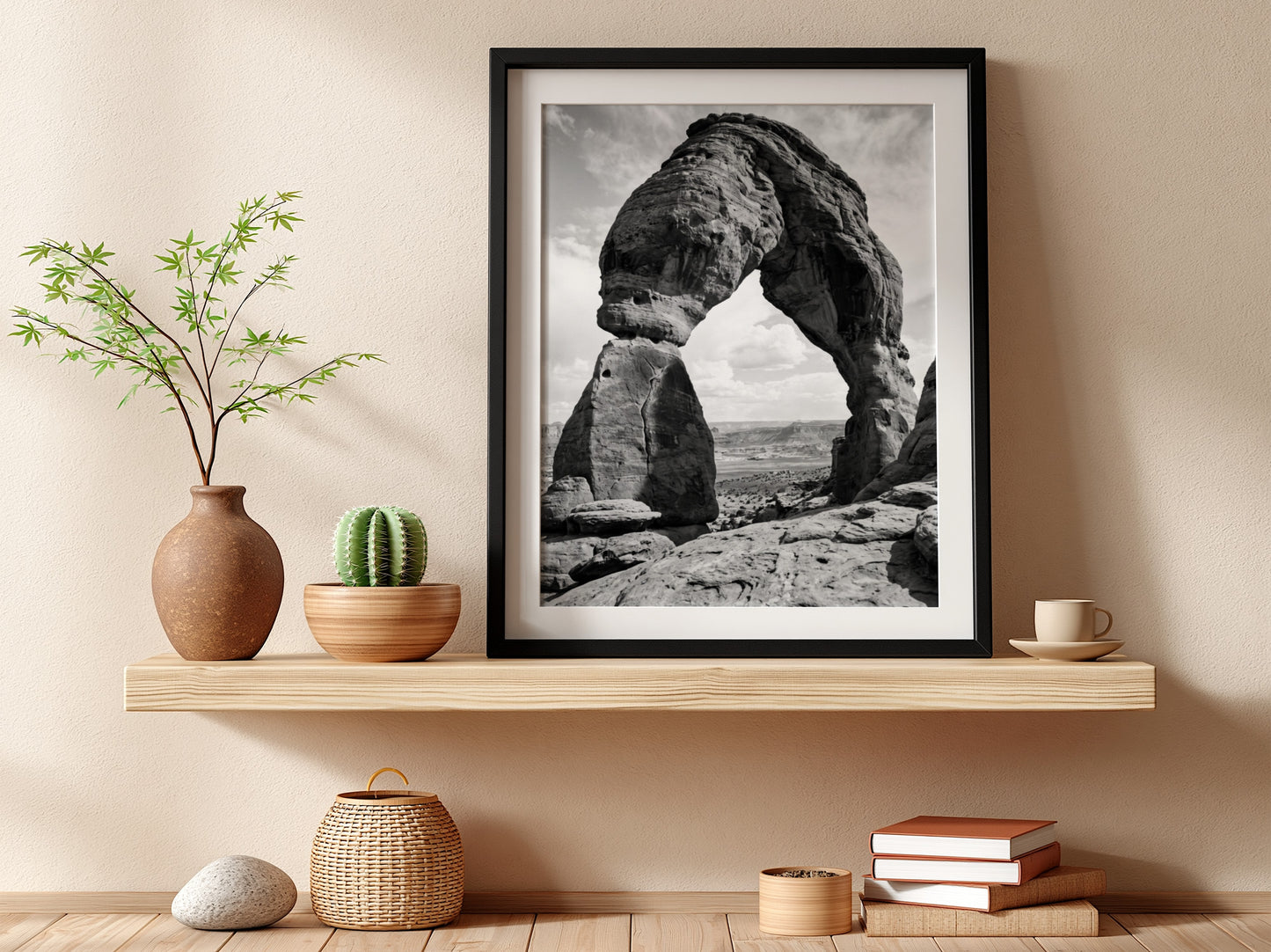 Black and white wall decor of sandstone arch in desert with textured rock and cloudy sky