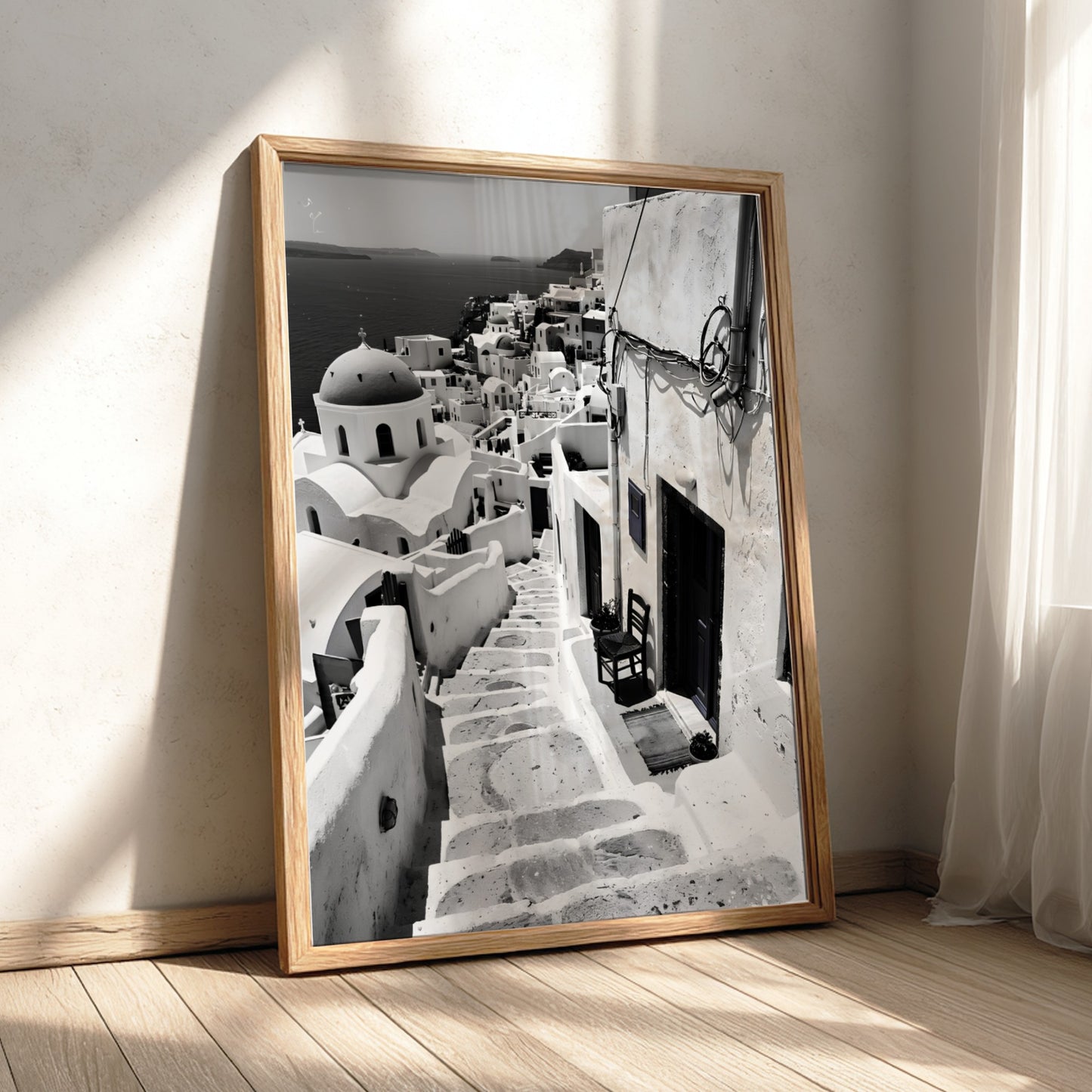 Black and white photography poster showing Santorini steps with white buildings and domed church