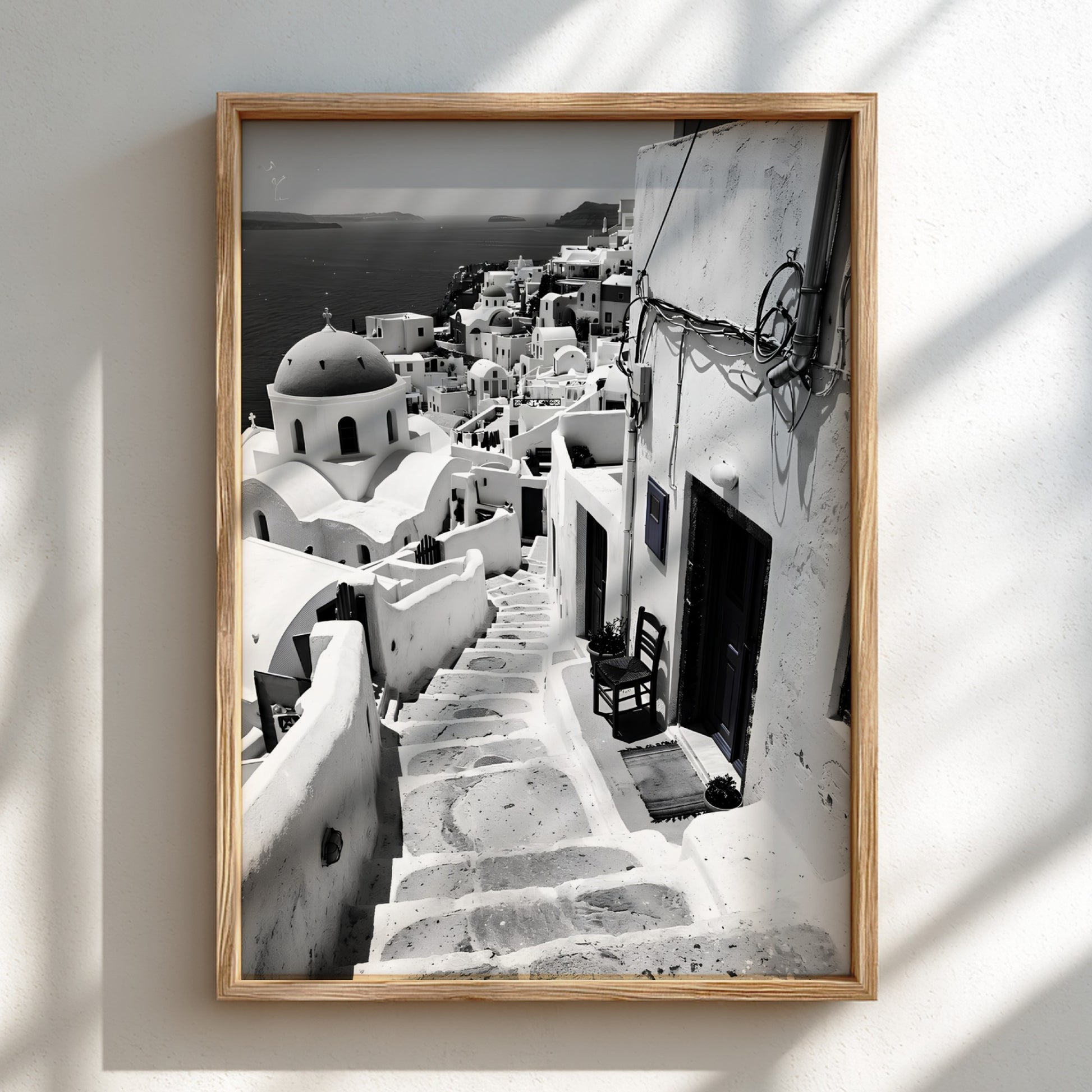 Black and white photography poster showing Santorini steps with white buildings and domed church