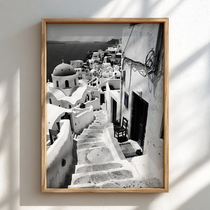 Black and white photography poster showing Santorini steps with white buildings and domed church