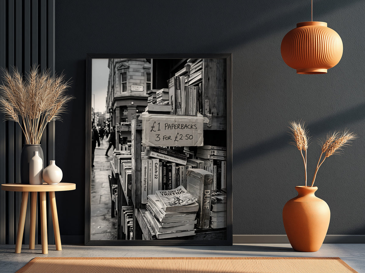 Black and white poster of secondhand bookstall with paperbacks and handwritten price sign