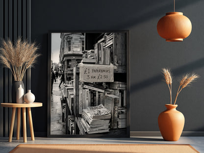 Black and white poster of secondhand bookstall with paperbacks and handwritten price sign
