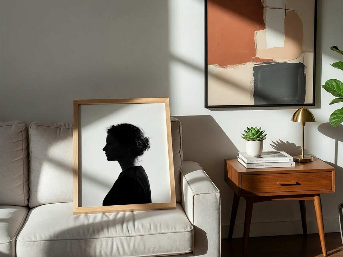 Wall decor featuring a minimalist silhouette profile of a woman in black against bright white background with