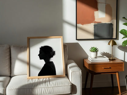 Wall decor featuring a minimalist silhouette profile of a woman in black against bright white background with