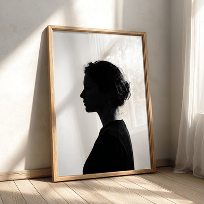 Wall decor featuring a minimalist silhouette profile of a woman in black against bright white background with