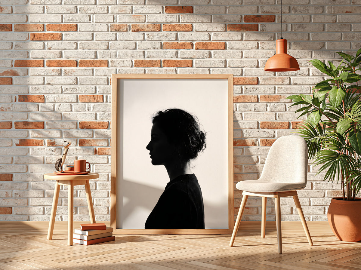 Wall decor featuring a minimalist silhouette profile of a woman in black against bright white background with