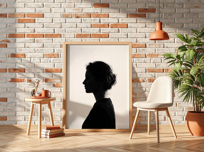 Wall decor featuring a minimalist silhouette profile of a woman in black against bright white background with