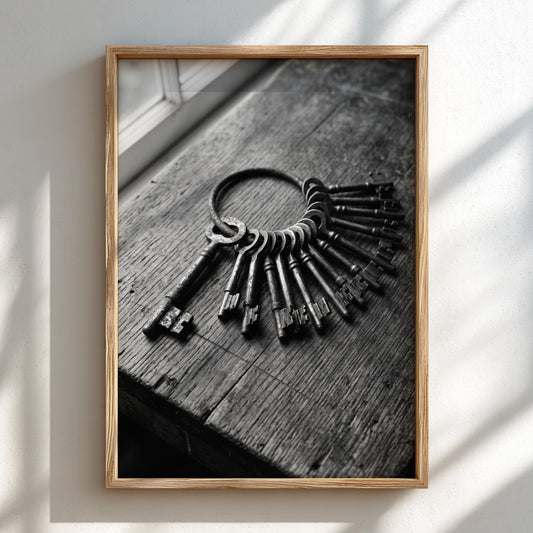 Black and white wall decor showing vintage skeleton keys on rustic wooden surface