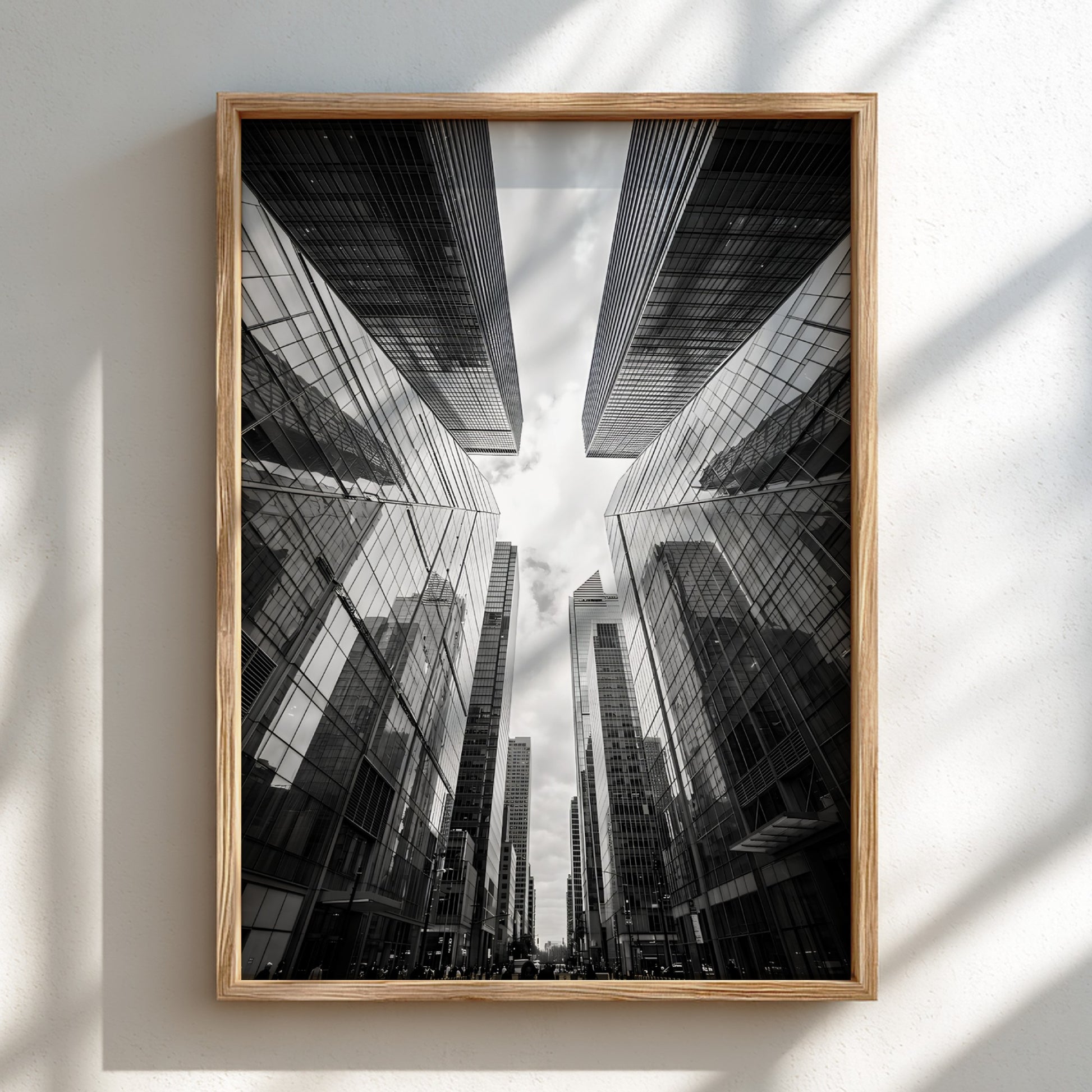 Wall decor featuring black-and-white urban photography of skyscrapers converging with reflective glass