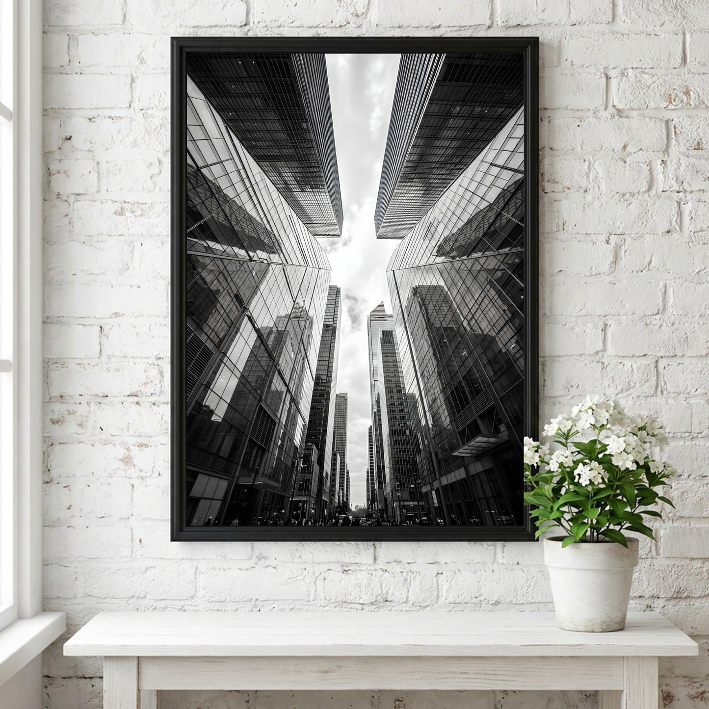 Wall decor featuring black-and-white urban photography of skyscrapers converging with reflective glass