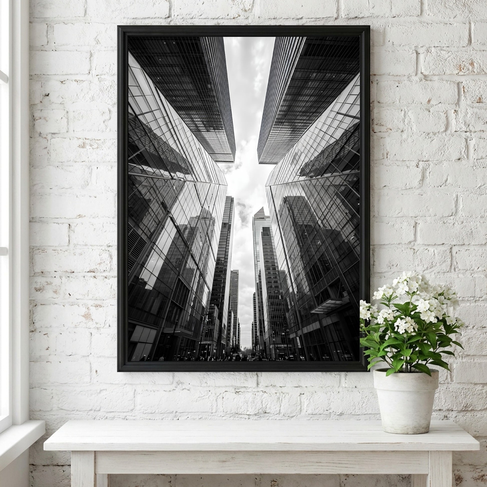 Wall decor featuring black-and-white urban photography of skyscrapers converging with reflective glass