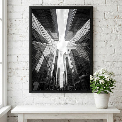 Wall decor featuring black-and-white urban photography of skyscrapers converging with reflective glass