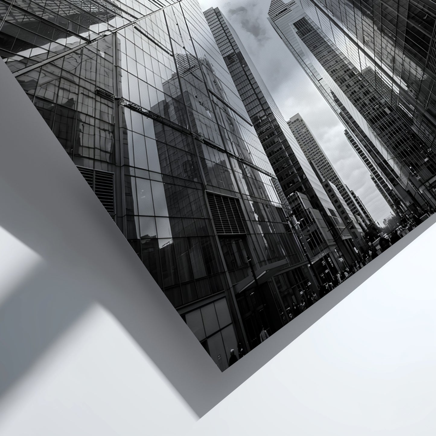 Wall decor featuring black-and-white urban photography of skyscrapers converging with reflective glass